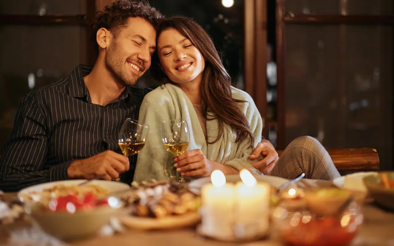 Couple enjoying a cozy candlelit dinner together.