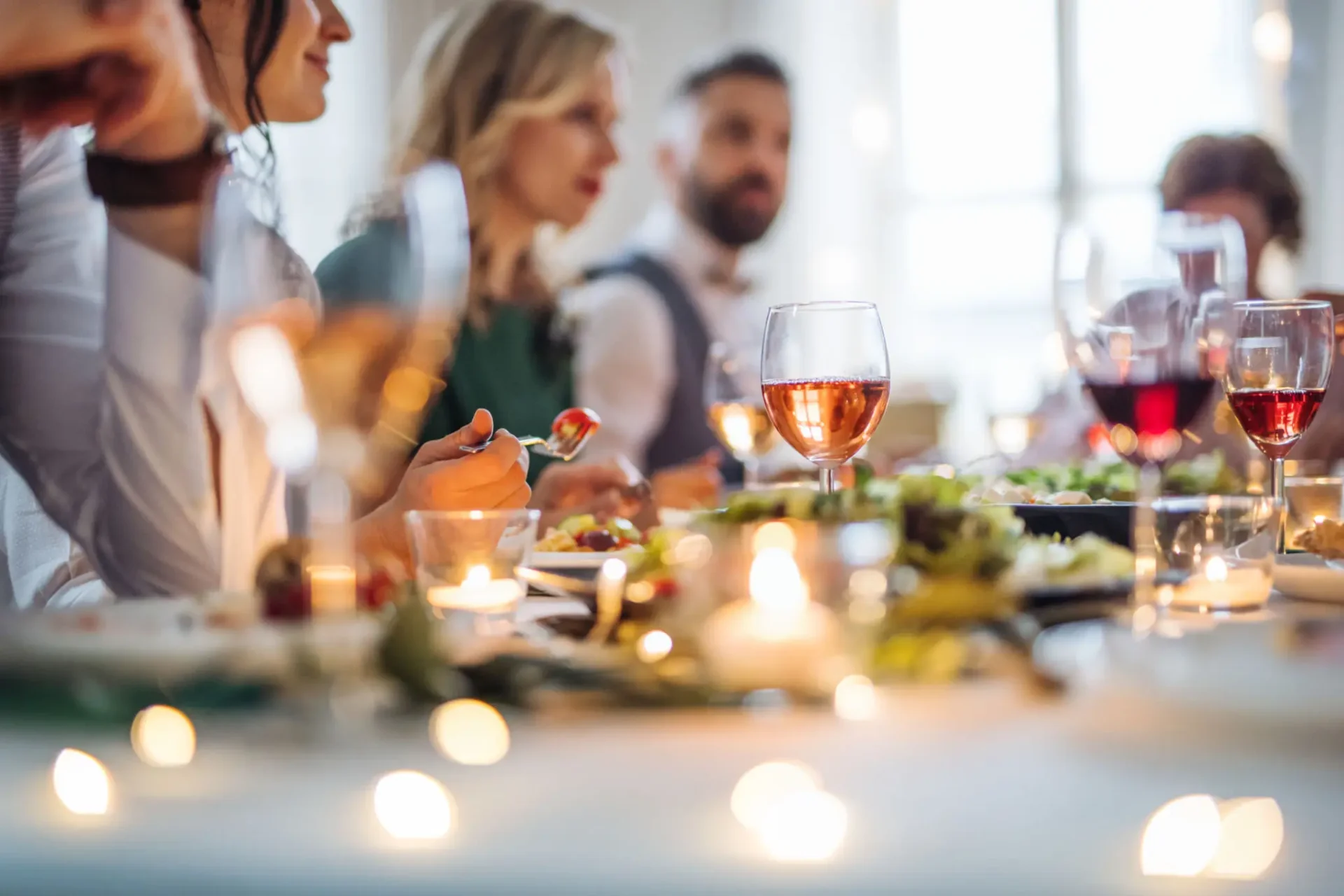 People enjoying a meal together at a warmly lit table.